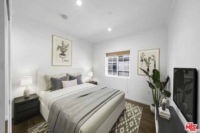 bedroom featuring crown molding and dark wood-type flooring