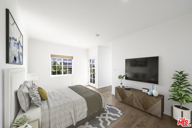 bedroom featuring ornamental molding and dark wood-type flooring