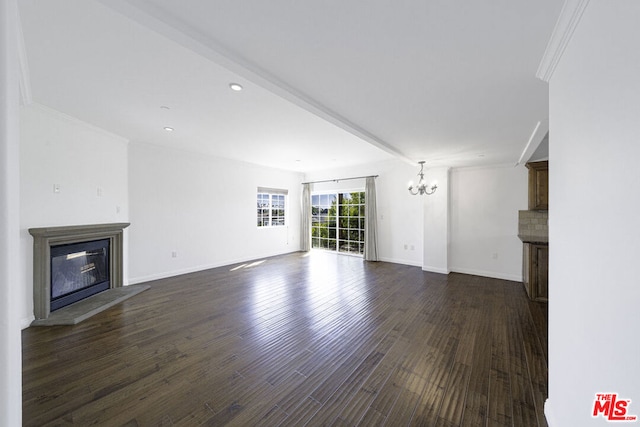 unfurnished living room featuring dark hardwood / wood-style floors and an inviting chandelier