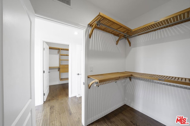 walk in closet featuring hardwood / wood-style flooring