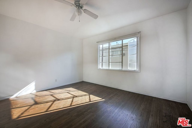 spare room with dark hardwood / wood-style floors and ceiling fan