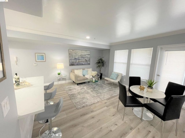 dining room featuring light hardwood / wood-style floors and crown molding