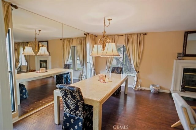 dining space with dark hardwood / wood-style flooring and plenty of natural light