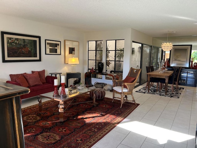 tiled living room featuring an inviting chandelier