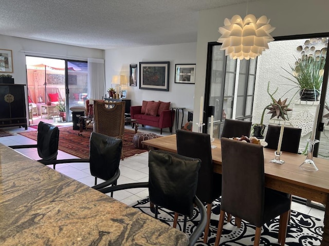 tiled dining area featuring a textured ceiling