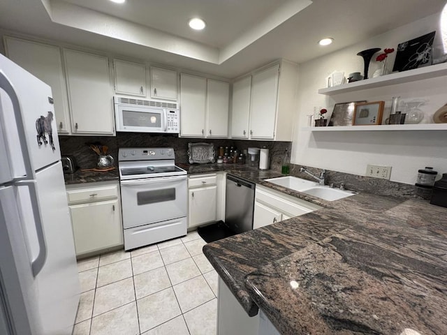 kitchen with backsplash, a raised ceiling, sink, and white appliances