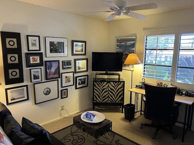 home office with a textured ceiling, carpet floors, and ceiling fan