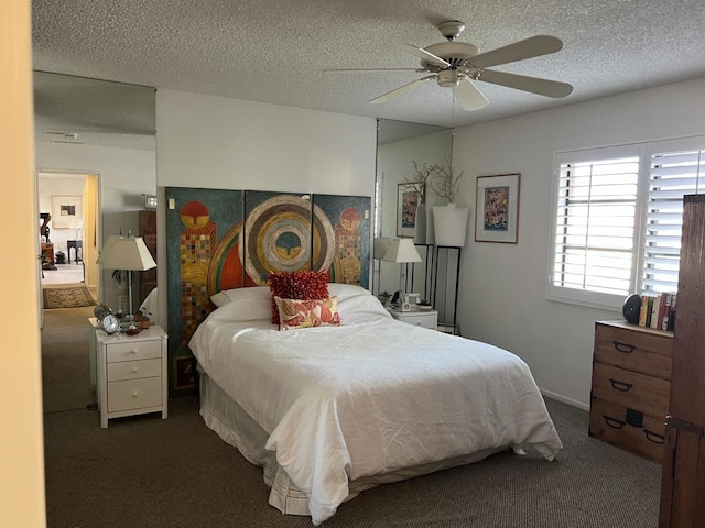 bedroom featuring dark colored carpet, a textured ceiling, and ceiling fan