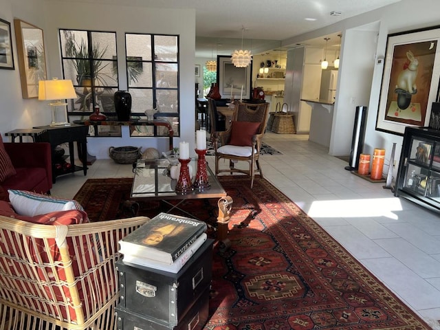 tiled living room featuring a notable chandelier