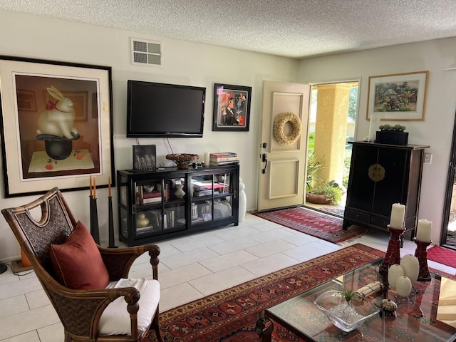 tiled living room with a textured ceiling