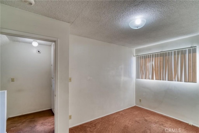 spare room with carpet flooring and a textured ceiling