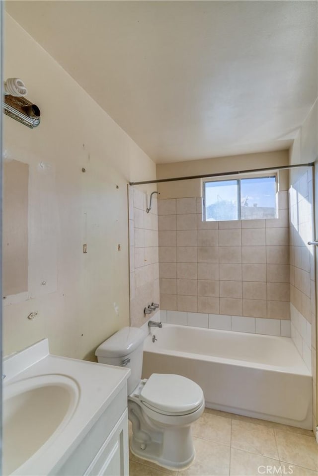 full bathroom with toilet, tiled shower / bath combo, tile patterned flooring, and vanity