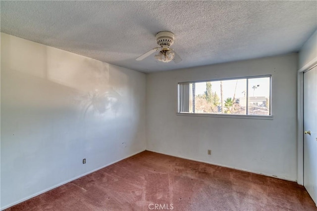 unfurnished room featuring a textured ceiling, a ceiling fan, and carpet