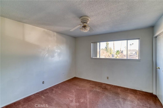 carpeted spare room with ceiling fan and a textured ceiling