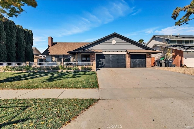 view of front of house with a front yard and a garage