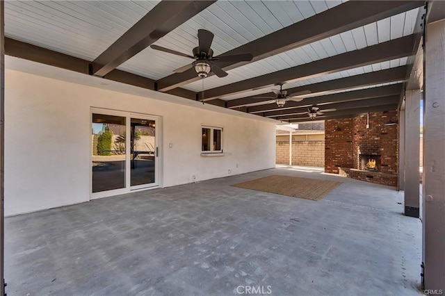 view of patio / terrace featuring ceiling fan and an outdoor brick fireplace