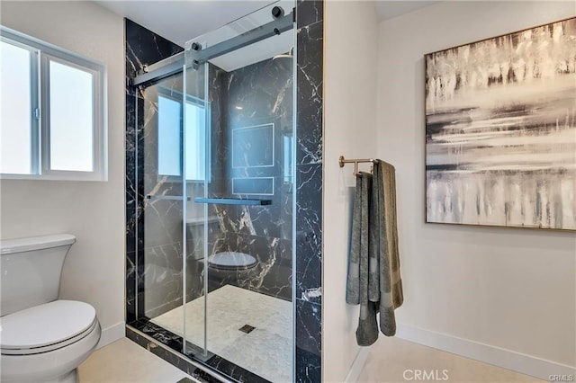 bathroom with tile patterned flooring, toilet, and an enclosed shower