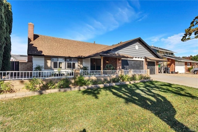 view of front of home with a garage and a front lawn