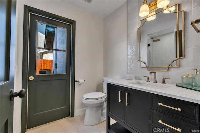 bathroom with tile patterned flooring, vanity, and toilet