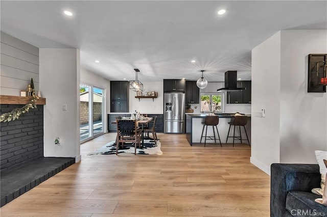 dining area with light wood-type flooring and a wealth of natural light