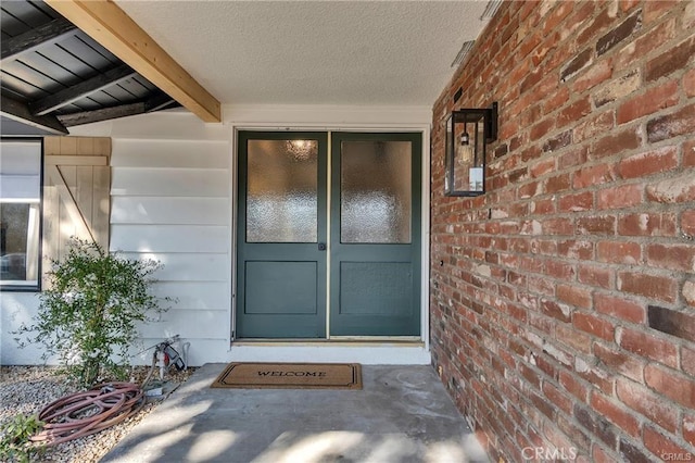 view of exterior entry featuring a porch