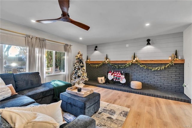 living room with ceiling fan and hardwood / wood-style flooring