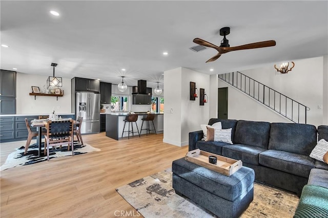 living room featuring ceiling fan and light hardwood / wood-style flooring