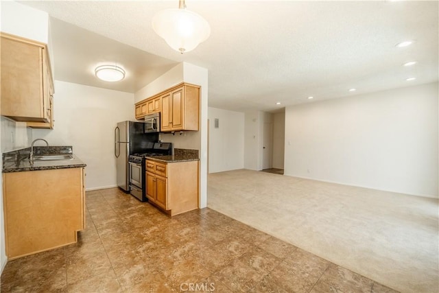 kitchen with sink, dark stone countertops, black gas stove, light colored carpet, and decorative light fixtures