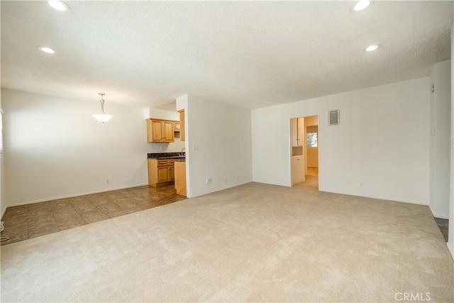 unfurnished living room featuring light colored carpet