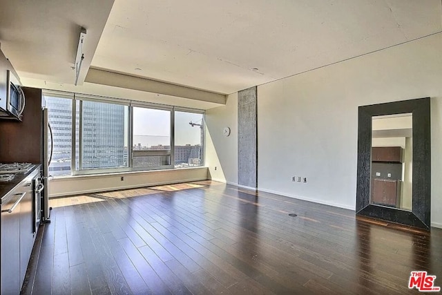 unfurnished living room featuring dark hardwood / wood-style flooring