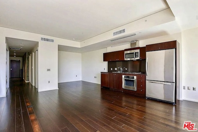 kitchen featuring dark brown cabinets, stainless steel appliances, and dark hardwood / wood-style floors