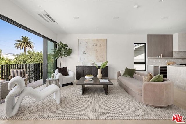 living room with light hardwood / wood-style floors and wine cooler