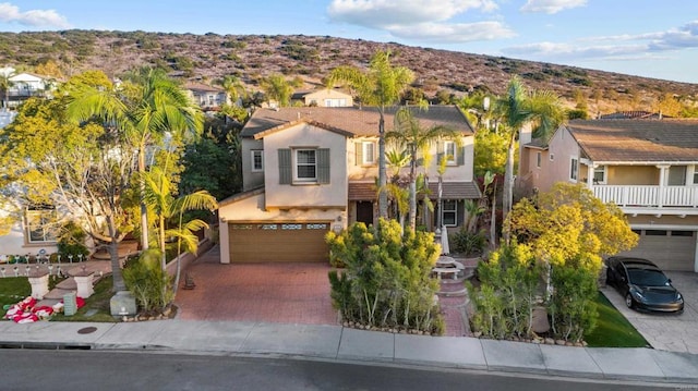 view of front of property featuring a garage and a mountain view