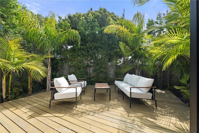 wooden terrace with an outdoor hangout area