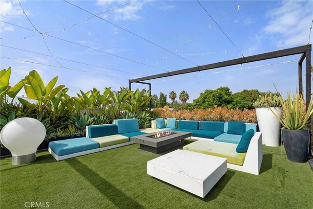 view of patio with an outdoor living space with a fire pit