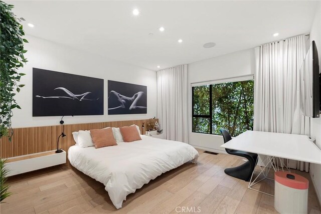 bedroom with wood-type flooring