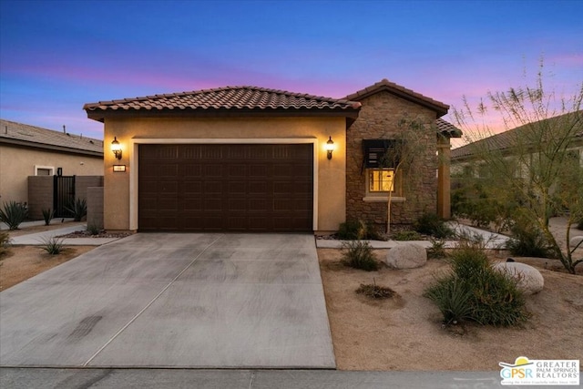 mediterranean / spanish house featuring a garage