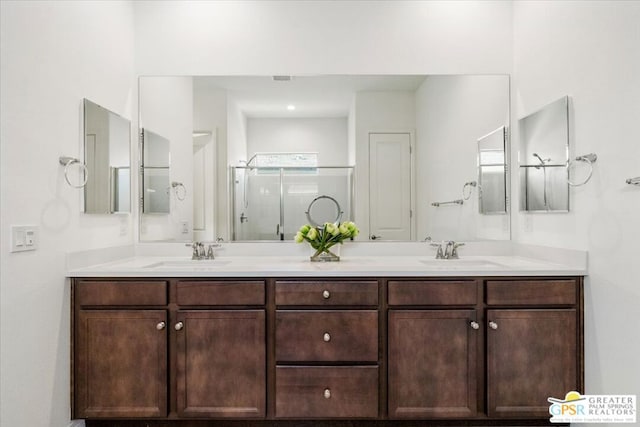 bathroom featuring vanity and an enclosed shower