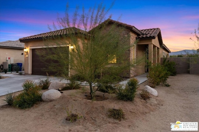 view of front facade featuring a mountain view and a garage