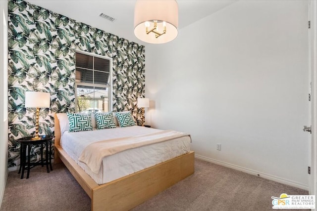 bedroom featuring carpet and an inviting chandelier