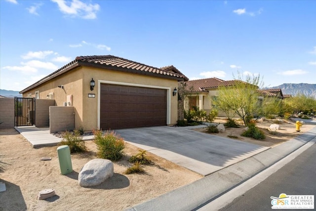 view of front of property with a mountain view and a garage