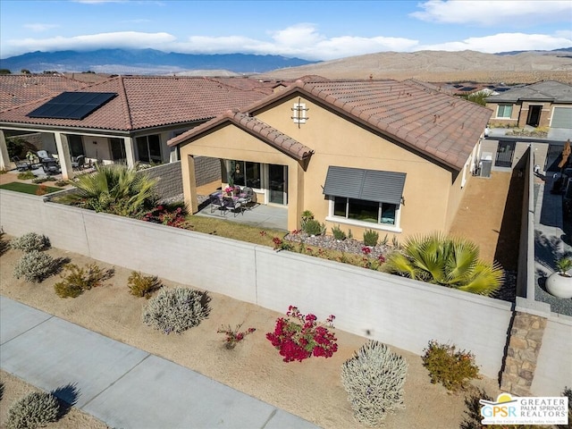 view of front of home featuring a mountain view and a patio