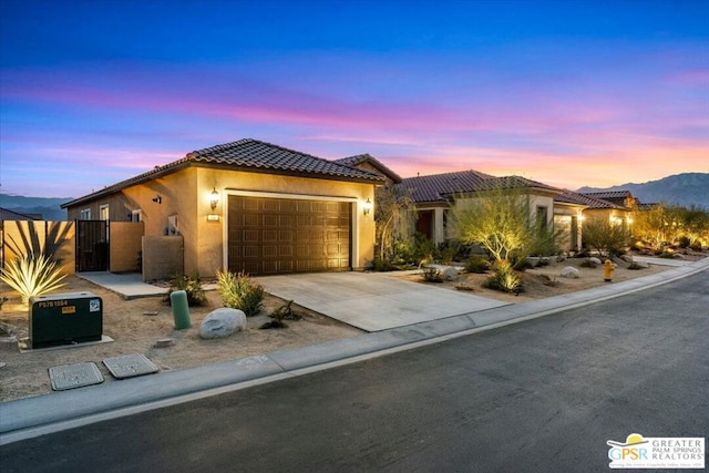 view of front of home featuring a mountain view and a garage