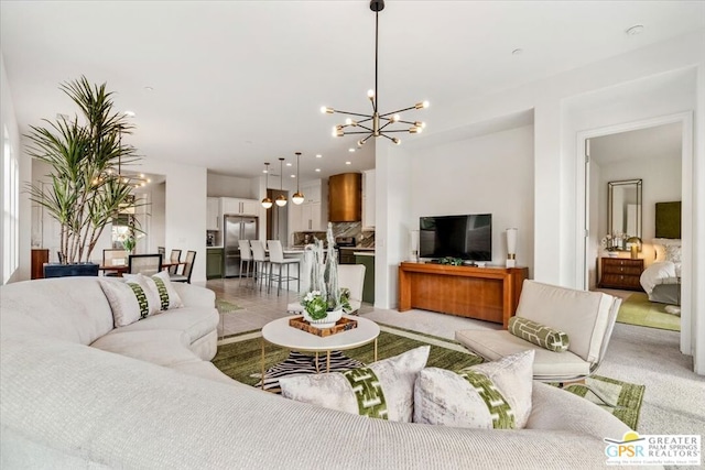 living room with light colored carpet and a chandelier