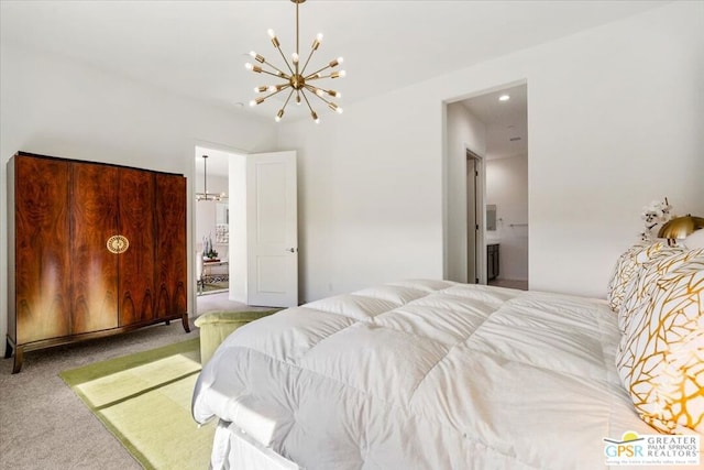 bedroom with carpet flooring, connected bathroom, and a chandelier