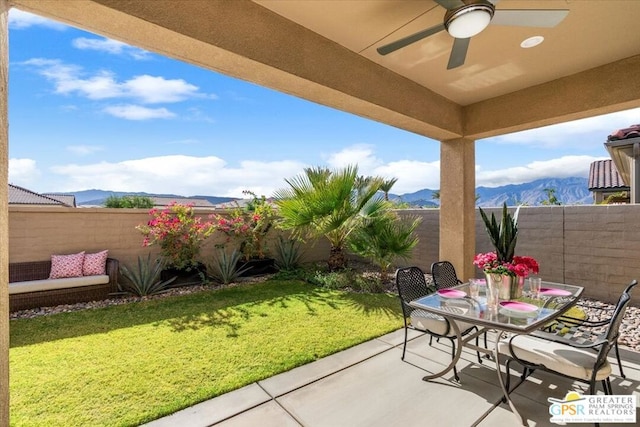 view of patio with a mountain view and ceiling fan