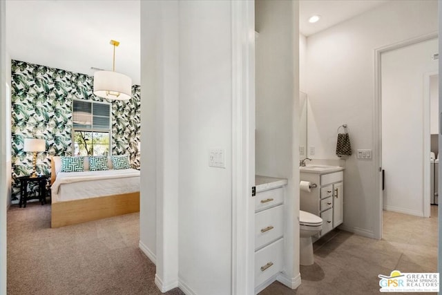 bathroom featuring vanity, toilet, and independent washer and dryer