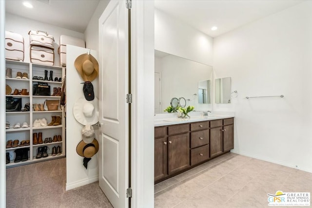 bathroom featuring tile patterned flooring and vanity