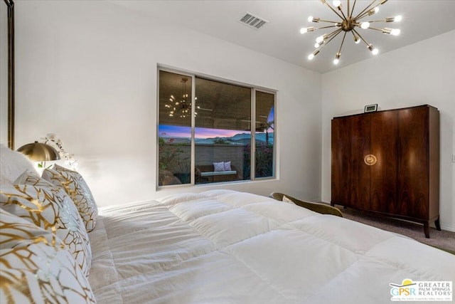 bedroom with carpet and a notable chandelier