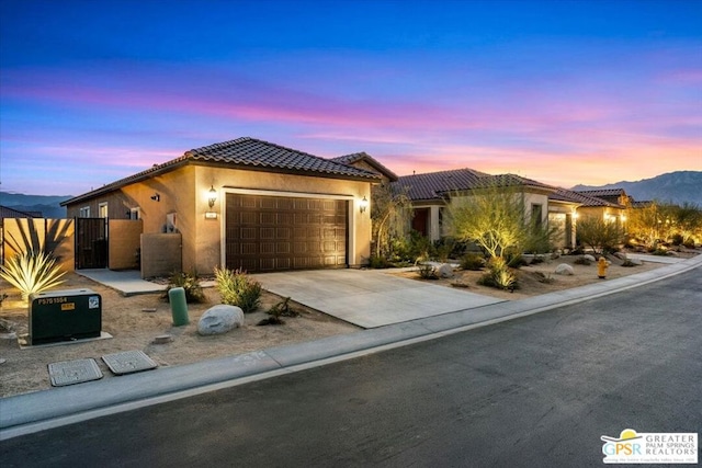 view of front of home featuring a mountain view and a garage